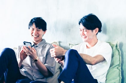 スマホでゲームをする男性